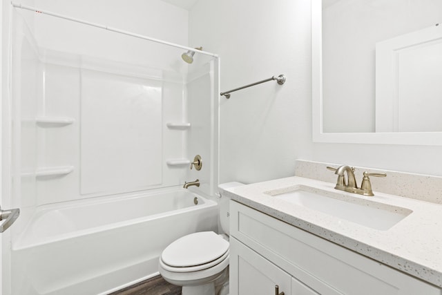 bathroom featuring toilet, vanity, and tub / shower combination