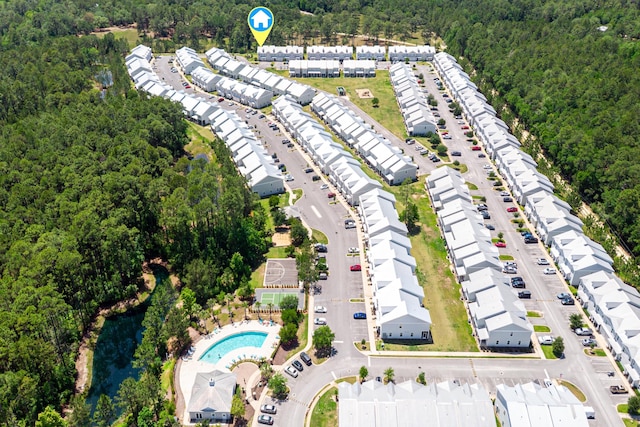 drone / aerial view of a forest and a pool
