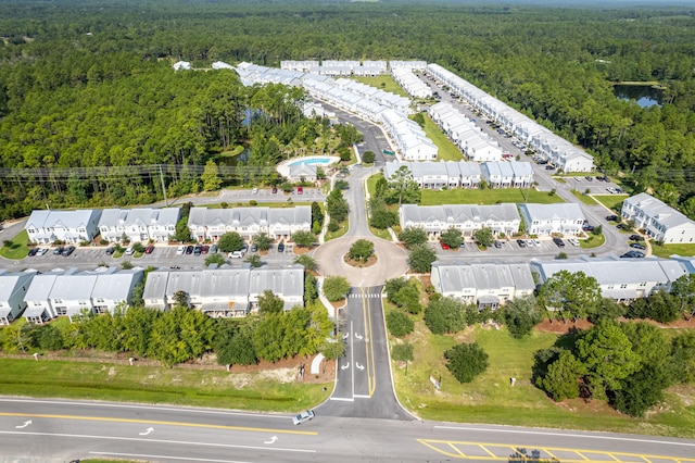 aerial view of property and surrounding area featuring a heavily wooded area