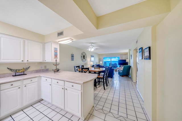5801 Thomas Dr Unit 620, Panama City Beach, FL 32408 - kitchen with ceiling fan, a peninsula, open floor plan, light tile patterned floors, and visible vents