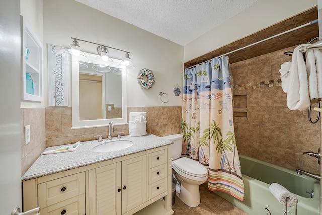 5801 Thomas Dr Unit 620, Panama City Beach, FL 32408 - full bathroom featuring tile walls, shower / bath combo, vanity, tile patterned floors, and toilet