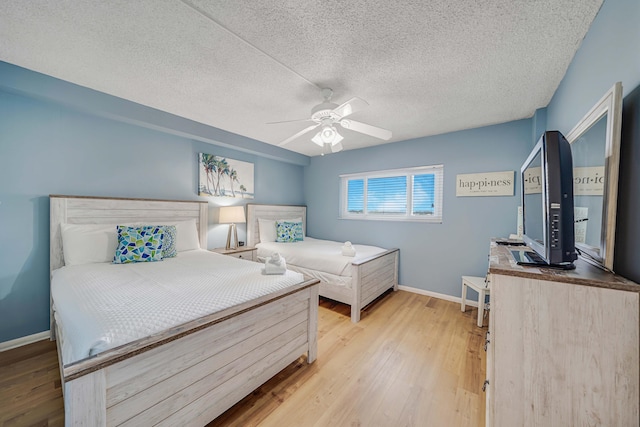 5801 Thomas Dr Unit 620, Panama City Beach, FL 32408 - bedroom featuring baseboards, a textured ceiling, and wood finished floors