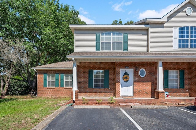1901 Cottage Grove Ln Unit 1, Niceville, FL 32578 - view of front facade featuring brick siding, covered porch, and uncovered parking