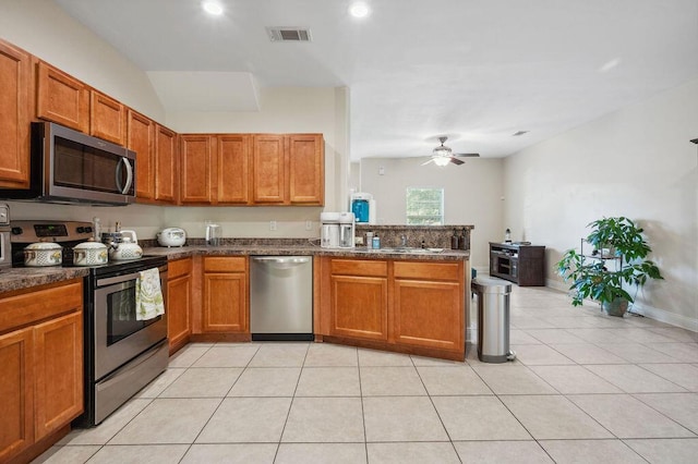 1901 Cottage Grove Ln Unit 1, Niceville, FL 32578 - kitchen featuring stainless steel appliances, a ceiling fan, a peninsula, brown cabinets, and recessed lighting