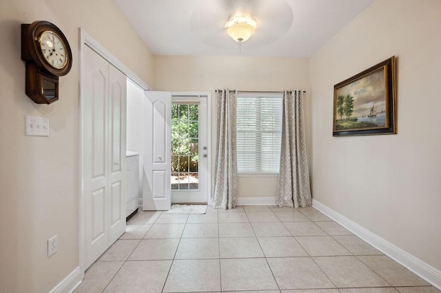 1901 Cottage Grove Ln Unit 1, Niceville, FL 32578 - doorway with baseboards, light tile patterned floors, and washer / clothes dryer