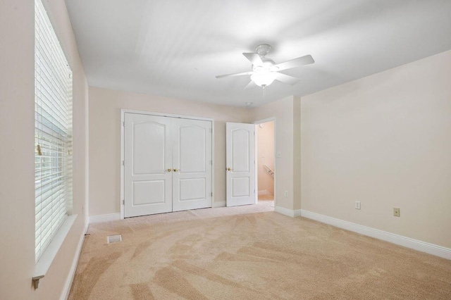 1901 Cottage Grove Ln Unit 1, Niceville, FL 32578 - unfurnished bedroom featuring light carpet, a closet, baseboards, and a ceiling fan