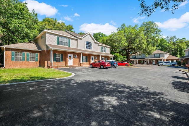 1901 Cottage Grove Ln Unit 1, Niceville, FL 32578 - multi unit property featuring uncovered parking, brick siding, and a front lawn