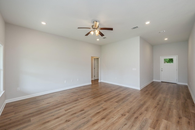 spare room with light wood-type flooring, visible vents, recessed lighting, ceiling fan, and baseboards