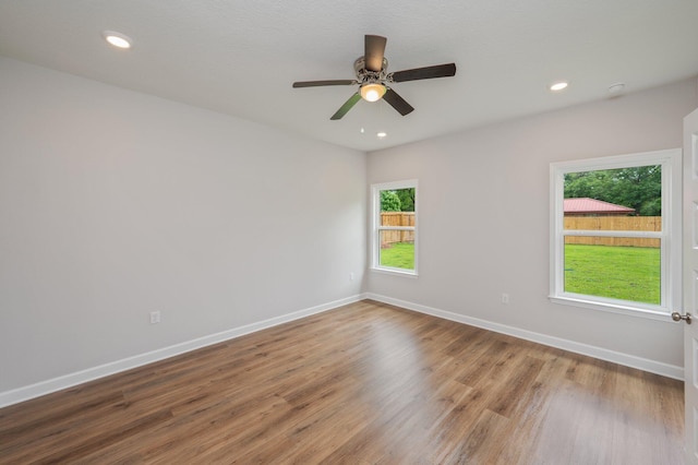 empty room featuring baseboards, recessed lighting, ceiling fan, and wood finished floors