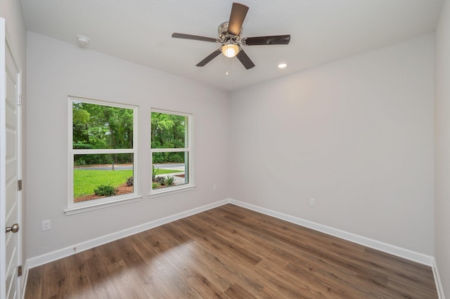 unfurnished room with baseboards, a ceiling fan, and wood finished floors