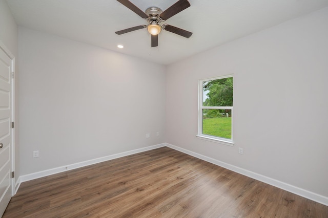 spare room featuring recessed lighting, baseboards, a ceiling fan, and wood finished floors