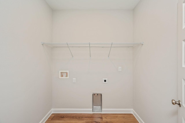 clothes washing area with light wood finished floors, electric dryer hookup, laundry area, hookup for a washing machine, and baseboards