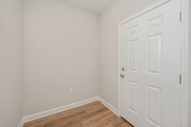 unfurnished room with baseboards and light wood-style floors