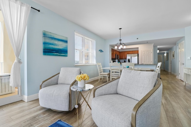 112 Seascape Dr Unit 310, Miramar Beach, FL 32550 - living area featuring light wood-style flooring, a chandelier, and baseboards