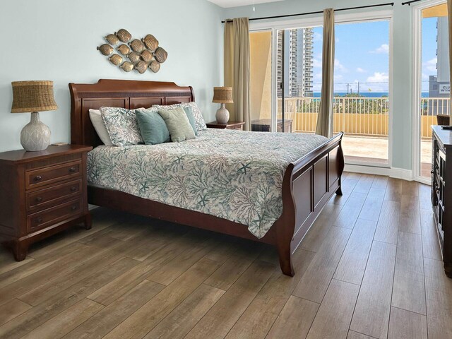 112 Seascape Dr Unit 310, Miramar Beach, FL 32550 - bedroom featuring access to exterior and hardwood / wood-style flooring