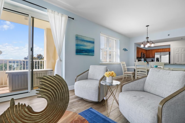 112 Seascape Dr Unit 310, Miramar Beach, FL 32550 - living area featuring light wood-style flooring, a chandelier, and baseboards