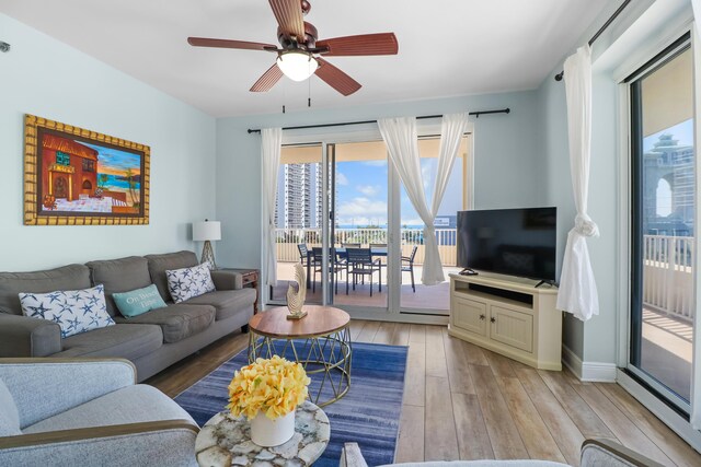 112 Seascape Dr Unit 310, Miramar Beach, FL 32550 - living room featuring light wood finished floors, a ceiling fan, and baseboards