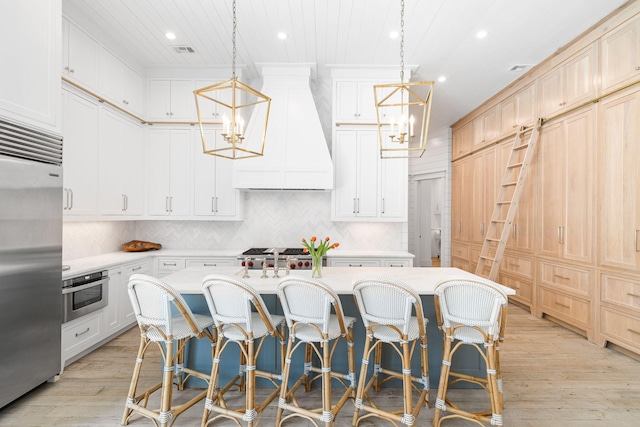 28 Rainer Ln, Inlet Beach, FL 32461 - kitchen with premium range hood, an inviting chandelier, stainless steel appliances, and light countertops