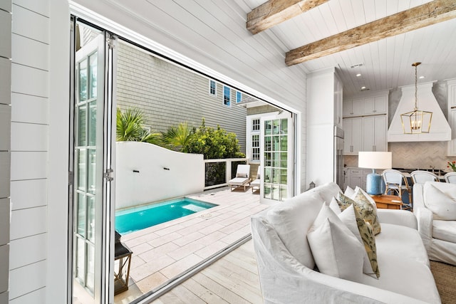 28 Rainer Ln, Inlet Beach, FL 32461 - living area featuring beamed ceiling, a wealth of natural light, wooden ceiling, and wood finished floors