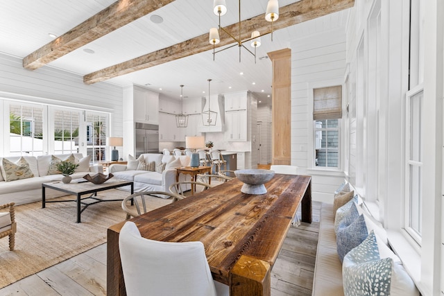 28 Rainer Ln, Inlet Beach, FL 32461 - dining space with wooden walls, beam ceiling, and light wood-type flooring