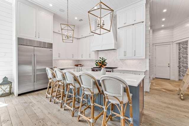 28 Rainer Ln, Inlet Beach, FL 32461 - kitchen featuring light wood-style floors, white cabinets, and built in fridge