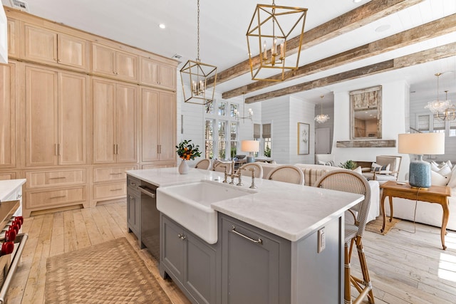 28 Rainer Ln, Inlet Beach, FL 32461 - kitchen with gray cabinetry, an inviting chandelier, a sink, open floor plan, and light wood-type flooring