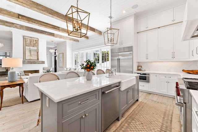 28 Rainer Ln, Inlet Beach, FL 32461 - kitchen featuring gray cabinetry, premium appliances, an inviting chandelier, a sink, and open floor plan