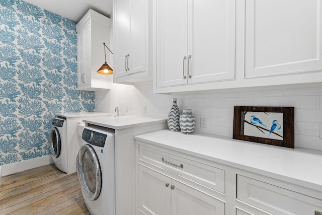 28 Rainer Ln, Inlet Beach, FL 32461 - laundry area featuring cabinet space, washing machine and clothes dryer, light wood finished floors, baseboards, and wallpapered walls