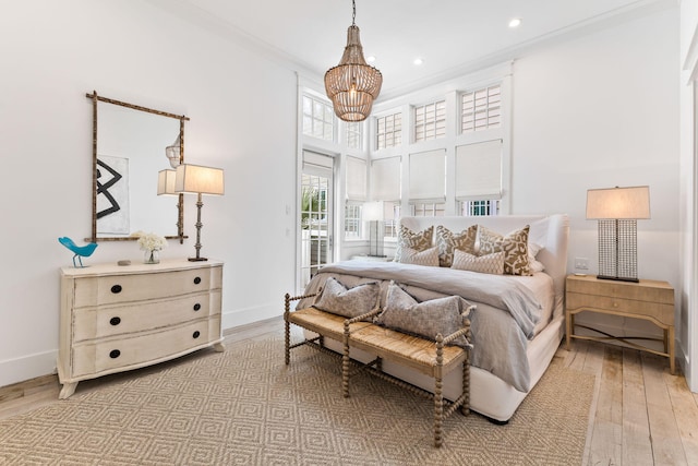 28 Rainer Ln, Inlet Beach, FL 32461 - bedroom with baseboards, hardwood / wood-style floors, an inviting chandelier, and a high ceiling