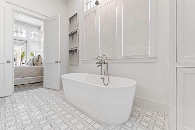 28 Rainer Ln, Inlet Beach, FL 32461 - full bathroom featuring a soaking tub, ensuite bathroom, baseboards, and tile patterned floors