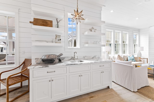 28 Rainer Ln, Inlet Beach, FL 32461 - interior space featuring open shelves, a wealth of natural light, light wood-style flooring, and a sink