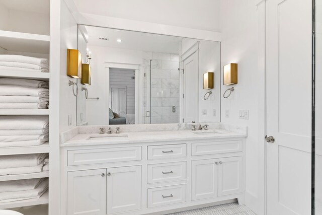28 Rainer Ln, Inlet Beach, FL 32461 - ensuite bathroom featuring a stall shower, ensuite bathroom, double vanity, and a sink