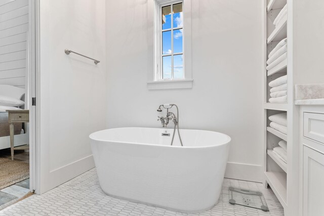 28 Rainer Ln, Inlet Beach, FL 32461 - bathroom featuring a soaking tub, baseboards, and tile patterned floors