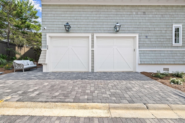 28 Rainer Ln, Inlet Beach, FL 32461 - garage featuring fence and decorative driveway