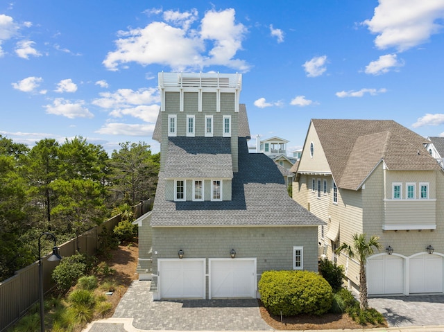 28 Rainer Ln, Inlet Beach, FL 32461 - view of front of home with a shingled roof, decorative driveway, fence, and a garage