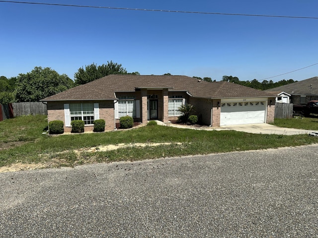 ranch-style house featuring fence, a garage, driveway, and brick siding