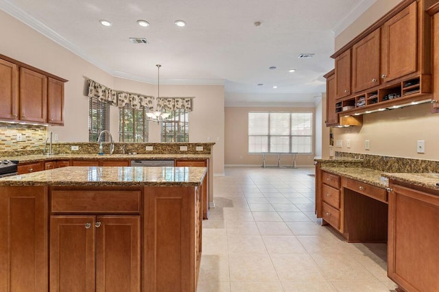kitchen featuring brown cabinets, a sink, ornamental molding, stone counters, and light tile patterned flooring