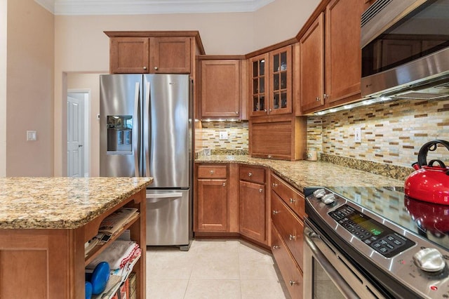 kitchen featuring appliances with stainless steel finishes, brown cabinets, decorative backsplash, and crown molding