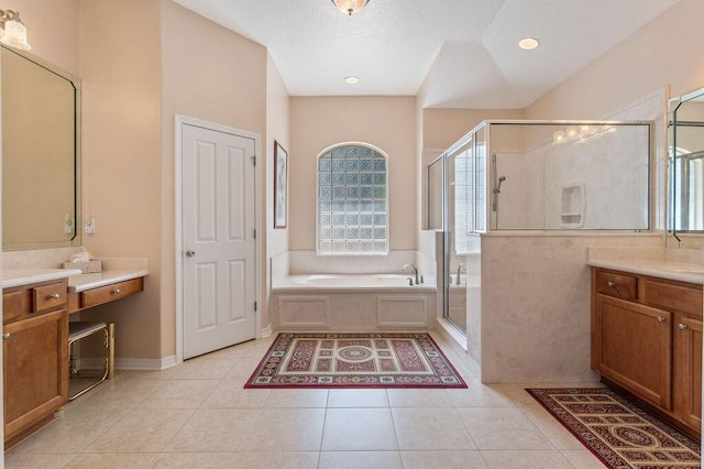 full bathroom featuring a shower stall, vanity, a bath, and tile patterned floors