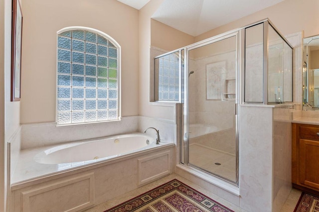 full bath with healthy amount of natural light, a shower stall, and vanity