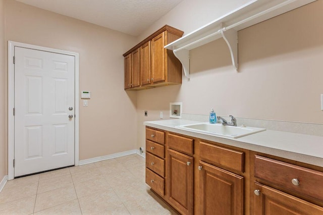 clothes washing area featuring hookup for an electric dryer, hookup for a washing machine, cabinet space, baseboards, and light tile patterned floors