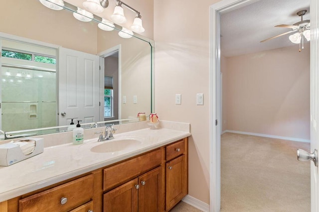 bathroom with vanity, ceiling fan, and baseboards