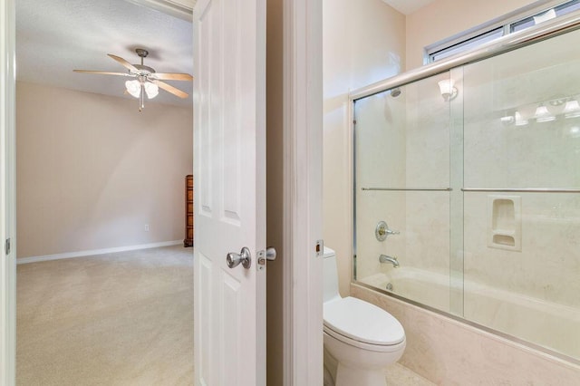 bathroom featuring toilet, ceiling fan, and shower / bath combination with glass door