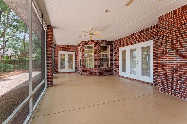 unfurnished sunroom with french doors and a ceiling fan