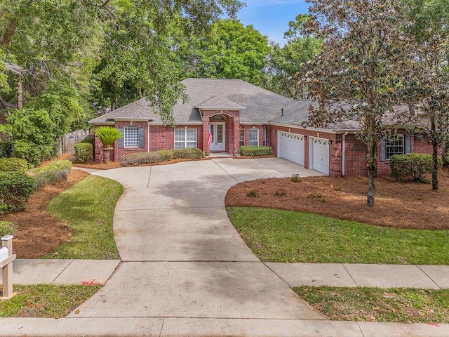 ranch-style house with brick siding, an attached garage, and concrete driveway