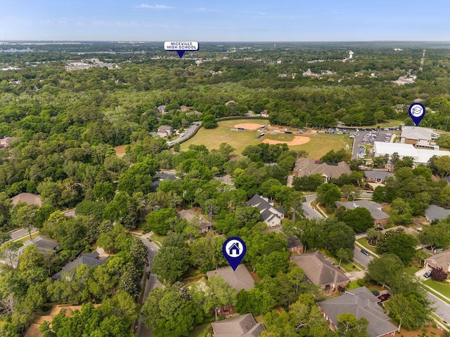 aerial view of residential area featuring a heavily wooded area