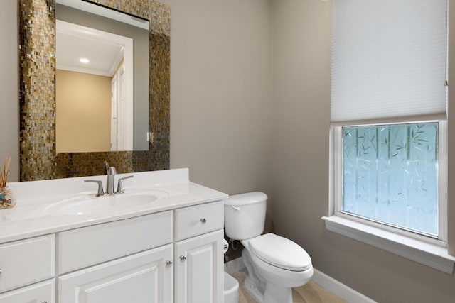 2021 Pine Island Cir, Miramar Beach, FL 32550 - half bath with vanity, decorative backsplash, baseboards, and toilet