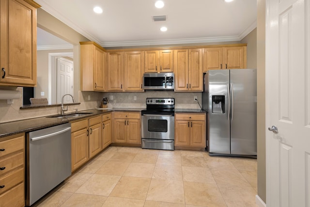 2021 Pine Island Cir, Miramar Beach, FL 32550 - kitchen with visible vents, a sink, appliances with stainless steel finishes, and crown molding