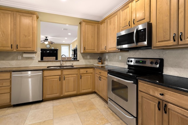 2021 Pine Island Cir, Miramar Beach, FL 32550 - kitchen featuring crown molding, ceiling fan, a sink, stainless steel appliances, and tasteful backsplash