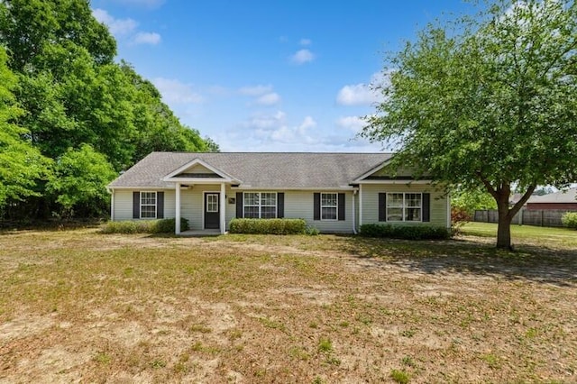 single story home with a front lawn and fence